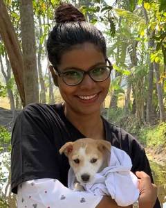 India team member Nafiza Khatun smiling and holding a puppy.